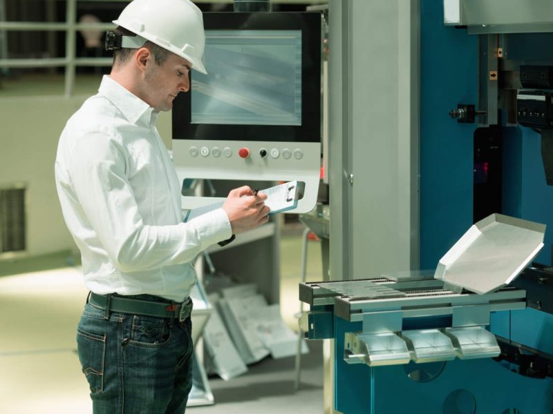 Technology Engineer Working in Factory. Holding check-list and supervising